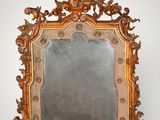 an ornately carved mirror on a white wall with a white background