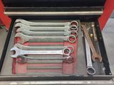 a lot of wrenches in a toolbox on the floor