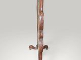 an image of a tall wooden stand with a clock on top of it