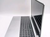 a silver laptop with a black keyboard on a white surface