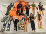 a lot of action figures that are laying on a bed
