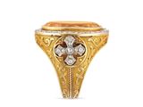 a close up of a gold and diamond ring on a white background