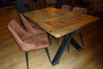 a wooden table with chairs around it on a hard wood floor