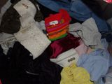 a pile of clothes that is sitting in a suitcase
