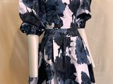 the mannequin is wearing a black and white floral print dress