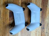 pair of white bicycle handlebars sitting on a wooden floor