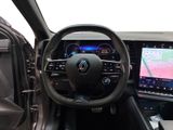 the interior of a car with a steering wheel, dashboard, and display screen