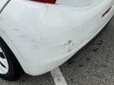 a white car that is parked in a parking lot
