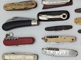 many different types of pocket knives on the table