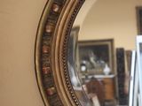 a mirror hanging on the wall in a room