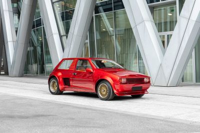 a red car that is parked in front of a building