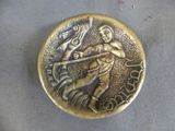 a gold coin with a man holding a fish