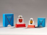 three small perfume bottles are sitting next to each other on a table