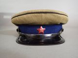 hat with red star on it sitting on top of a metal base