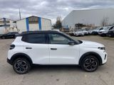 the white suv is parked in a parking lot with other cars