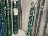 many rolls of green and orange plastic on the shelves