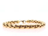 a close up of a gold bracelet on a white background