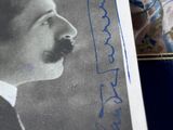 a picture of a man with a mustache and a book