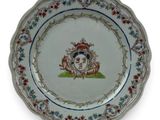 an image of a plate with a picture of a woman and a dog on it