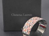 a close up of a bracelet on a box with a box in the background