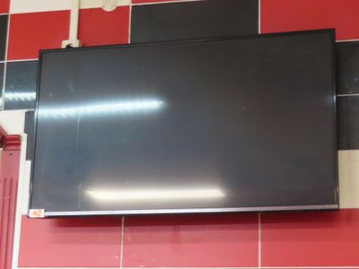 a flat screen tv mounted on the wall in a kitchen