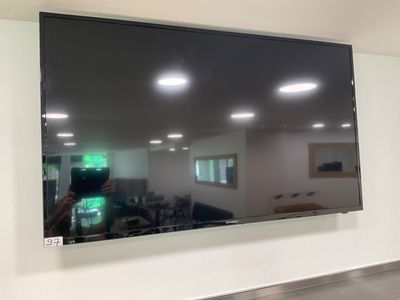 a flat screen tv hanging on the wall in a room