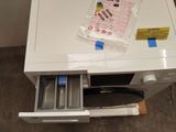 a small white table with a drawer in it