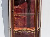 a small cabinet with a glass door on the top of it