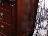 a wooden dresser with a black and white picture on it
