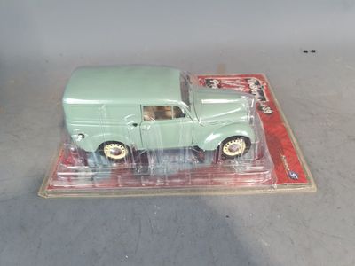 a green toy truck that is sitting on top of a box