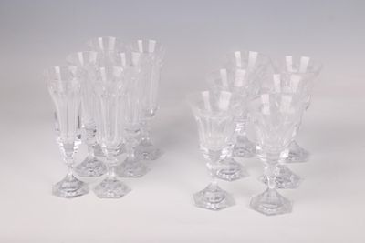 three clear glass wine glasses sitting on top of a white table