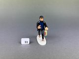 a small figurine of a man on a surfboard
