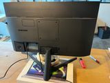 a computer monitor sitting on top of a wooden table