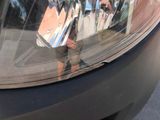 a reflection of a man taking a picture of himself in the mirror of a car