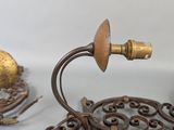 pair of antique brass candlesticks and a candle holder on a table