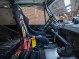 a seat in the back of a truck with a yellow seat belt