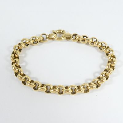 a close up of a gold chain bracelet on a white background