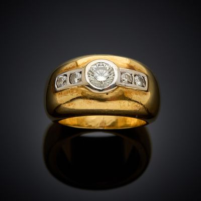 a close up of a gold ring with diamonds on a black surface