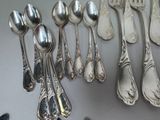 a lot of silver spoons and spoon spoons on a table