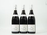 trois bouteilles de vin sont alignées sur une surface blanche