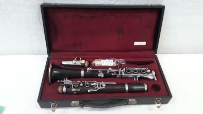 a black case with a silver and black clarinet in it