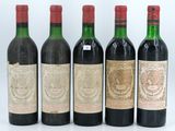 four bottles of wine are lined up in a row