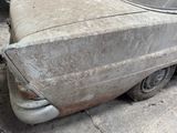 an old car that is sitting on the ground