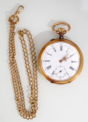 a gold pocket watch with a chain around it