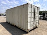 a white container sitting in the middle of a parking lot