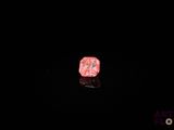 an image of a pink rock in the dark with a black background