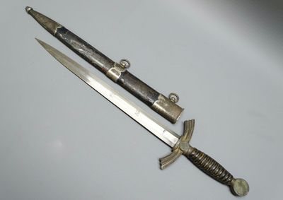 a knife that is laying next to a knife on a table