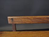 a close up of a wooden chair with a black background