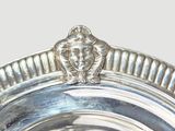 a close up of a silver plate with a lion head on it