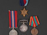 three medals and a medal on a black surface
